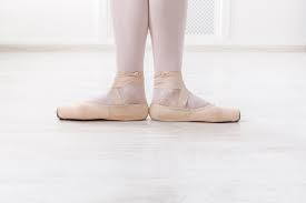 close up of ballerinas feet pointing out